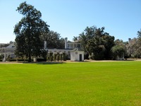 Across the lawn of Carriage Circle toward the main house (1914/1936) at Pebble Hill Plantation.