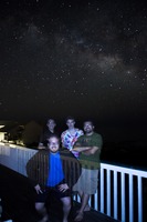 Erik Patten (front), David July, Tom Patten and Christian Popoli under the galactic plane of the Milky Way Galaxy visible in the night sky above St. George Island.