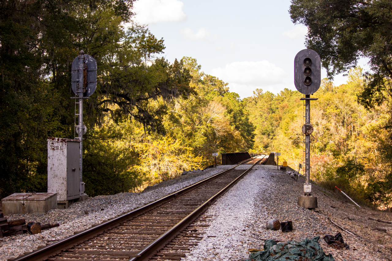 Track, signaling equipment and the railroad bridge over the Suwannee River near crossing 623389S at CSX Milepost SP 728.12, part of the former Seaboard Air Line Railroad, just outside of Suwannee River State Park.