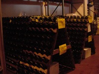 Rows of wine bottles are rotated on a schedule while they wait inside the Lakeridge Winery.