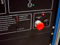 Emergency stop button on a control panel rack.