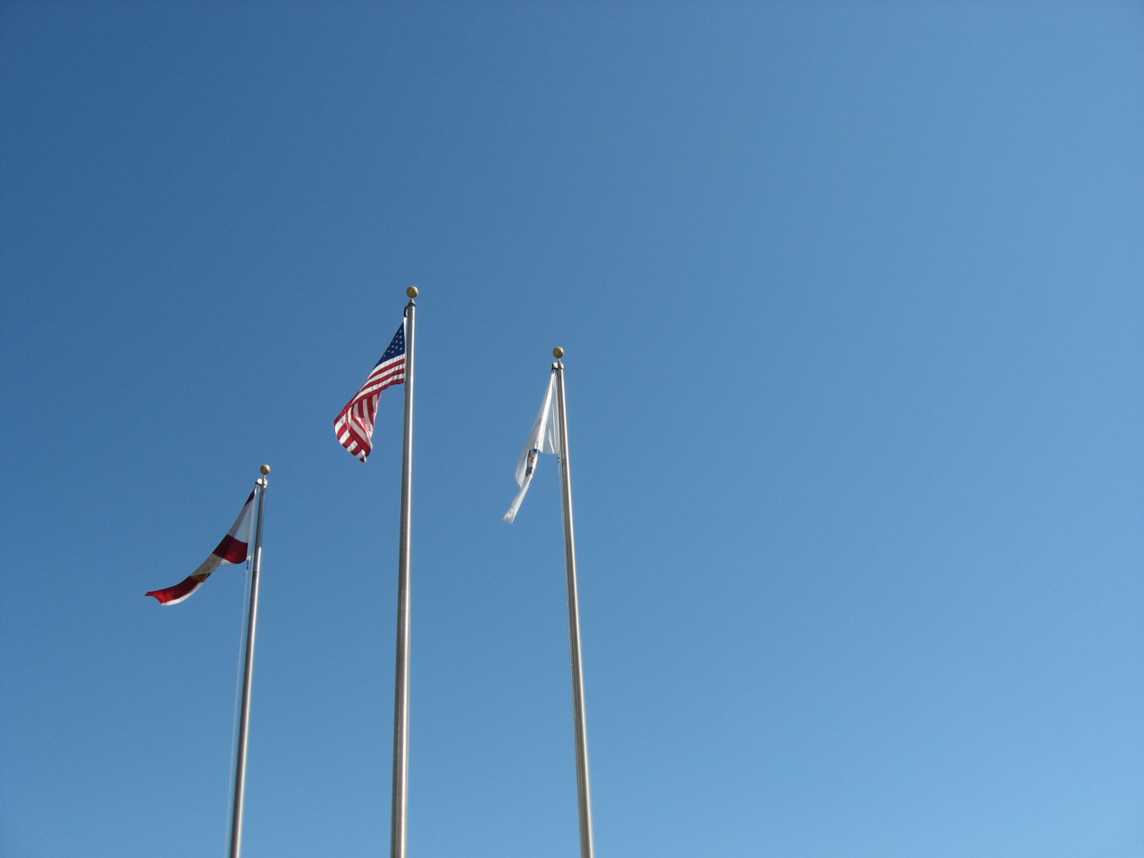 Three flags in front of the Mag Lab.