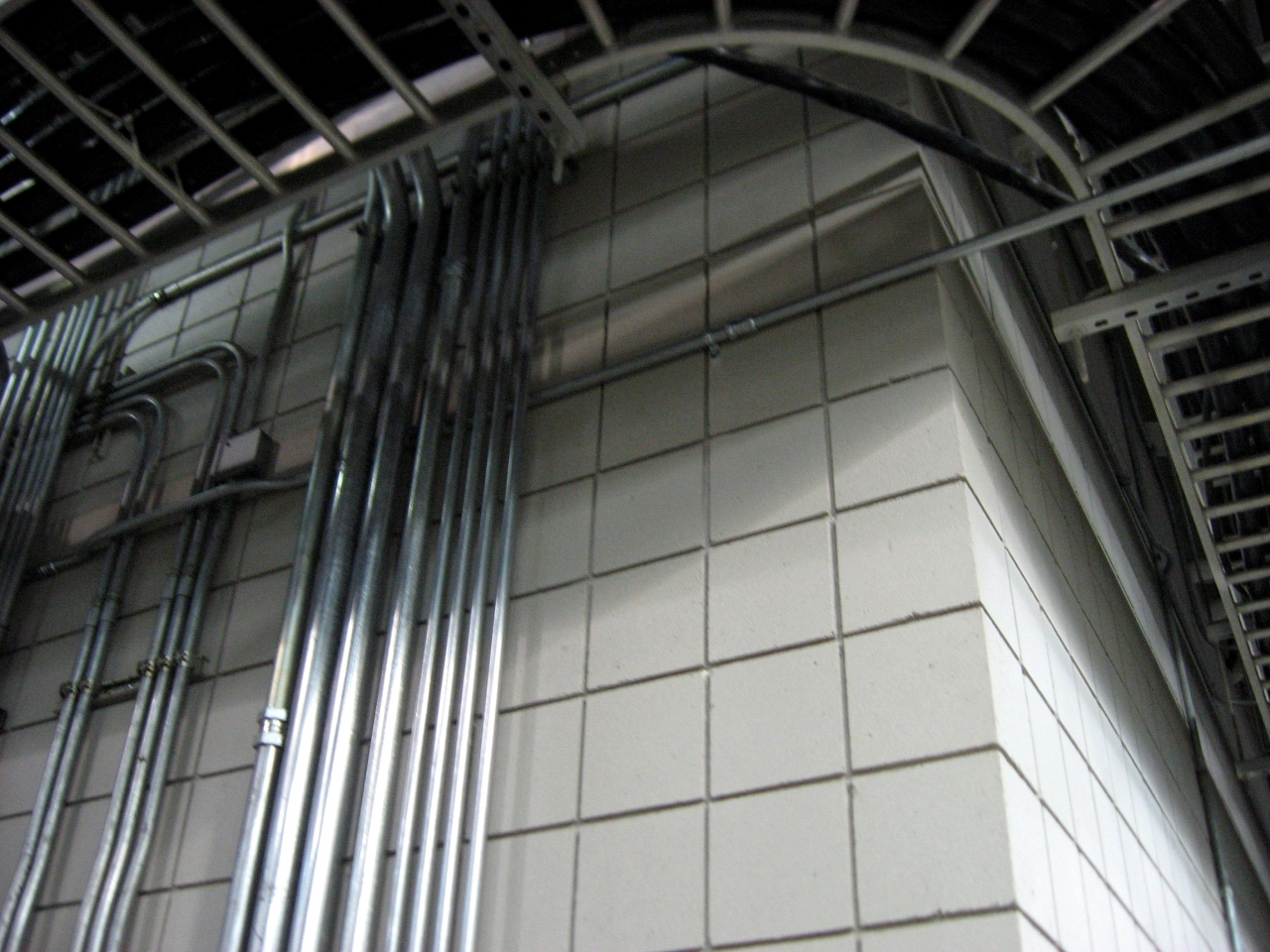Pipes and cables overhead the DC Field wing corridor.