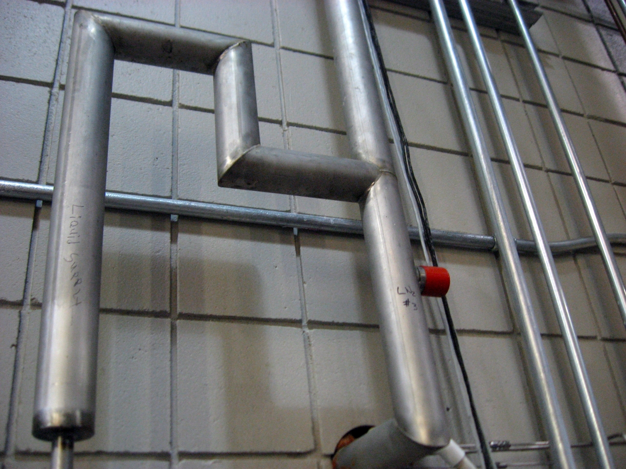 Liquid supply conduit in the DC Field wing test cell corridor.
