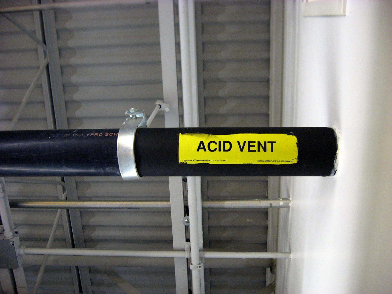 Overhead pipe labeled 'Acid Vent' in the research library.
