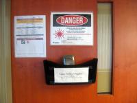 Laser radiation warning sign and safety goggles.