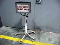 Portable 'Laser In Use Do Not Enter' sign at the DC Field wing optics lab.