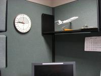Twenty-four hour clock and NOAA aircraft model in the office of CARCAH, the Chief Aerial Reconnaissance Coordination All Hurricanes unit of the National Hurricane Center.
