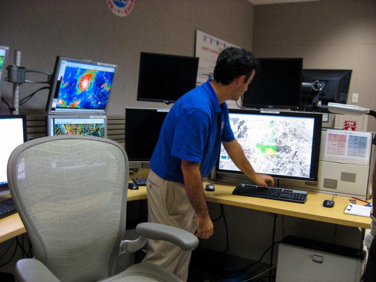 Hurricane Specialist John Cangialosi pulls up satellite imagery on a computer in the operations center of the National Hurricane Center.