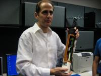 Meteorologist Steve Feuer shows off a dropsonde in the office of CARCAH, the Chief Aerial Reconnaissance Coordination All Hurricanes unit of the National Hurricane Center.