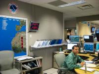 Senior Hurricane Specialist Daniel Brown working at his desk in the operations center of the National Hurricane Center.