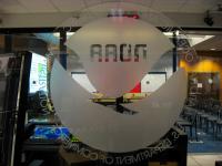 Etched NOAA logo on glass behind the broadcast desk in the operations center of the National Hurricane Center.