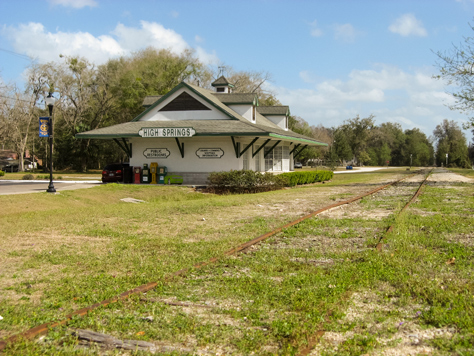 Photo Credit: David July — High Springs Chamber of Commerce building (2008) and the old Savannah, Florida and Western Railroad tracks (1884) running southeast through High Springs near Main Street, High Springs, Florida: 19 February 2012