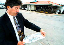 Photo Credit: Monessen Valley Independent — Donald M. Yoder with his plans to replace the Belle Vernon Howard Johnson's on 19 March 1999