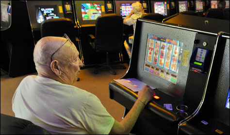 Photo Credit: Bob Self/The Times-Union — Customer Lou Andino from East Arlington plays one of the electronic sweepstakes games at Royal Times Sweepstakes, Jacksonville, Florida