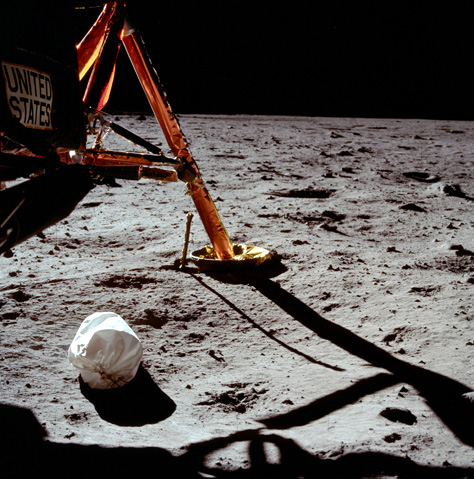 Photo Credit: NASA/Neil Armstrong/JSC — AS11-40-5850 Lunar Surface with Lunar Module Strut, 70mm Hasselblad, Kodak Ektachrome SO168 160ASA Color, Film Magazine 40/S, 20 July 1969 at ~0303:49 UTC