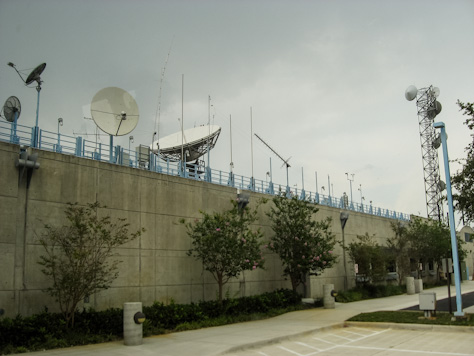 Photo Credit: David July — Rooftop satellite dishes, antennas and the eastern exterior wall of the National Hurricane Center, 11691 SW 17th Street, Miami, Florida, 15 May 2012