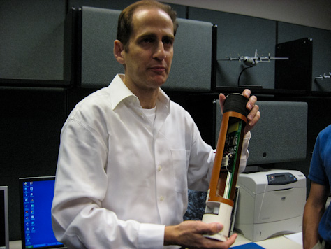 Photo Credit: David July — Meteorologist Steve Feuer shows off a dropsonde in the office of CARCAH, the Chief Aerial Reconnaissance Coordination All Hurricanes unit of the National Hurricane Center, 11691 SW 17th Street, Miami, Florida, 15 May 2012