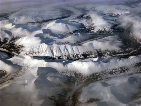 Photo Credit: David July — Peering down at the mountains from 32,000 feet, somewhere over western Canada, 13 March 2008