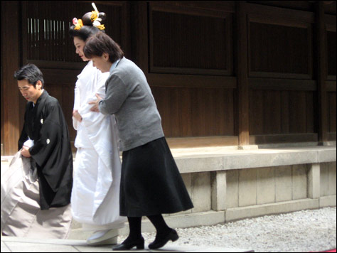 Photo Credit: David July — A Japanese bride is escorted through Meiji Shrine, Shibuya, Tokyo, Japan, 16 March 2008