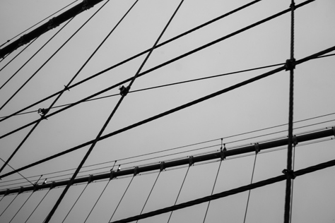 Photo Credit: David July — Cables leading up to the western side of the eastern tower of the Brooklyn Bridge (1883) from the pedestrian and cyclist promenade, Brooklyn, New York: 26 January 2014