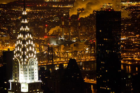 Photo Credit: David July — The majestic art deco Chrysler Building (1930) and nondescript Trump World Tower (2001) with the Queensboro Bridge (1909) and Ravenswood Generating Station (1963) beyond from the 86F observation deck of the Empire State Building (1931), New York, New York: 24 January 2014