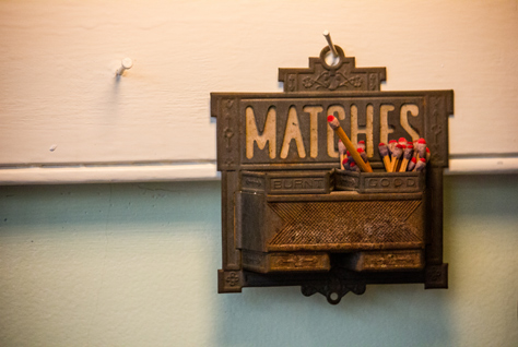 Photo Credit: David July — Antique metal match holder complete with wooden matches hung from a nail on the kitchen wall in the Woodrow Wilson House (1915), Washington, District of Columbia: 31 January 2014