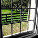 Photo Credit: David July — Horse paddock from inside the Stable Complex (1928) Carriage Room at Pebble Hill Plantation, 1251 US Highway 319 South, Thomasville, Georgia, 12 February 2011