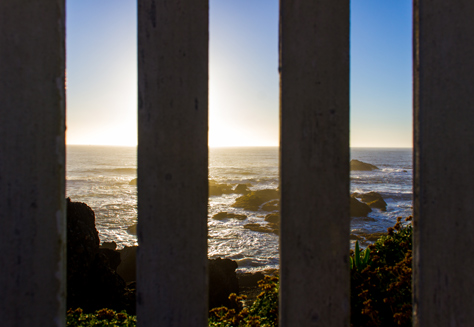 Photo Credit: David July — Pacific Ocean sunset through the posts of the wooden platform on the edge of the rocky promontory upon which the Pigeon Point Lighthouse (1871) is built, Pescadero, California: 30 January 2013
