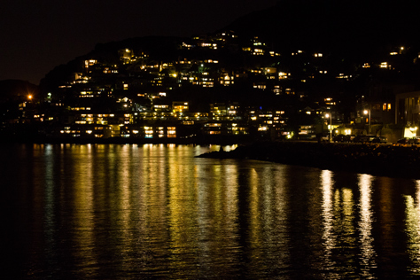 Photo Credit: David July — Illuminated homes on South Street, Edwards Avenue and Hi Vista Road just south of The Trident reflecting in the bay, Sausalito, California, 29 January 2013