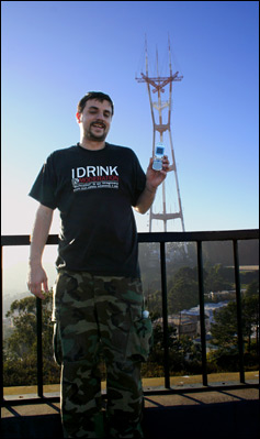 Photo Credit: Marc Malonzo IV and Danny Patterson — Marc Malonzo IV and David July (on telephone) on Twin Peaks pose in front of Sutro Tower, Christmas Tree Point Road, San Francisco, California, 17 January 2009