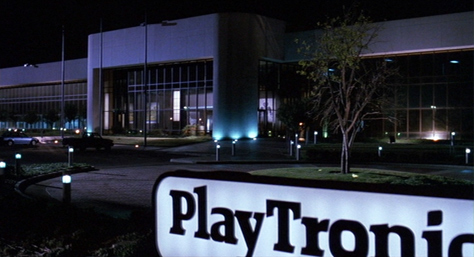 Photo Credit: Universal Pictures and Phil Alden Robinson — 'Sneakers' film frame: Sign and driveway cicle in front of the PlayTronics building