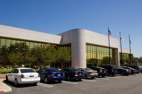 Photo Credit: David July — Front entrance, parking and triad of flags at the front of 400 National Way (1984), the fictional PlayTronics headquarters building in 'Sneakers' (1992), Simi Valley, California: 22 August 2013