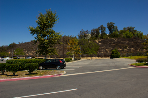 Photo Credit: David July — My rental car, a water tank and the last row of parking east of 400 National Way (1984), the fictional PlayTronics headquarters building in 'Sneakers' (1992), Simi Valley, California: 22 August 2013