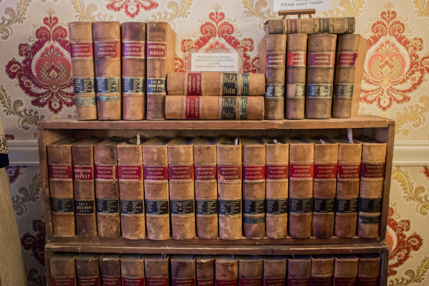 A collection of 'Pacific Reporter' case law books in their original shipping crates in the sitting room of the Wickersham House (1904) museum in Pioneer Park.