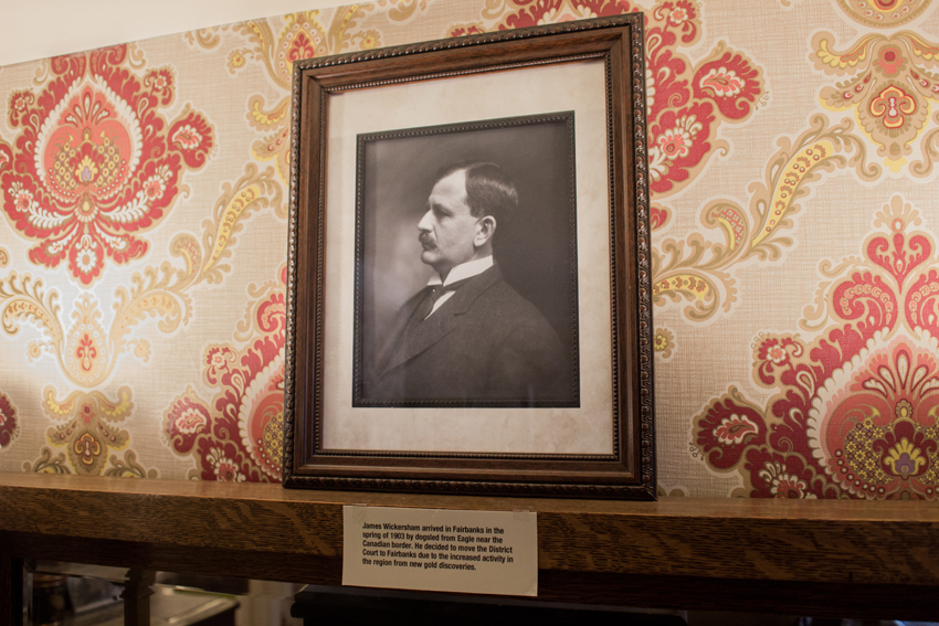 A framed photograph of James Wickersham in profile on display atop a dresser in the front room of the Wickersham House (1904) museum in Pioneer Park.