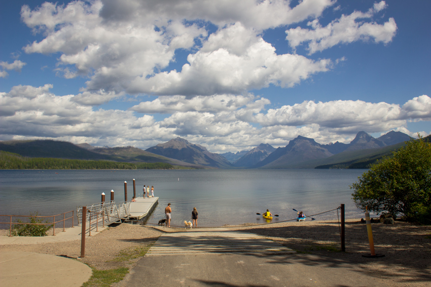 The Apgar Village boat ramp and dock on Lake McDonald with the mountains of Glacier National Park beyond.