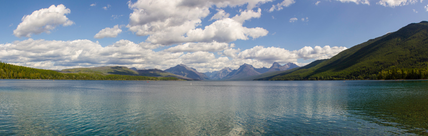 Panorama of Lake McDonald, valley and mountains from the Apgar Village boat ramp dock in Glacier National Park.