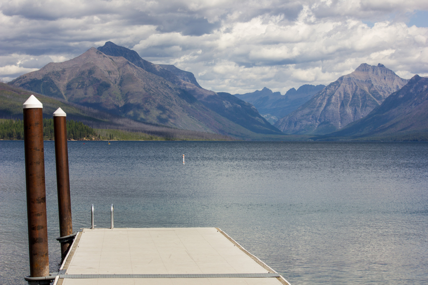 The Apgar Village boat ramp and dock on Lake McDonald with the mountains of Glacier National Park beyond.