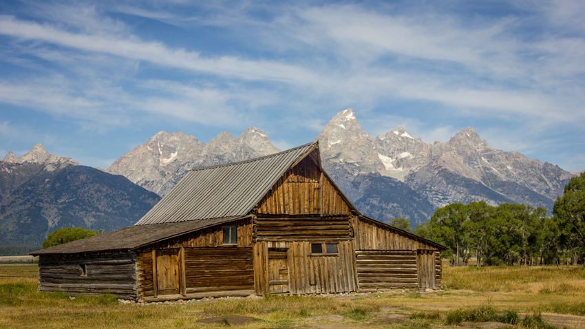 Mountains of the Teton Range and the iconic T. A. Moulton Barn (1910–1945), all that remains of the Thomas Alma and Lucille Moulton homestead in the Mormon Row Historic District at Grand Teton National Park.