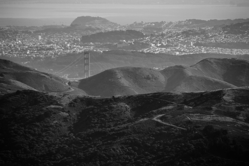 The Golden Gate Bridge (1937) poking up from behind the Marin Headlands with San Francisco beyond from atop the Mount Tamalpais East Peak summit at the end of the Plank Walk Trail in Mount Tamalpais State Park