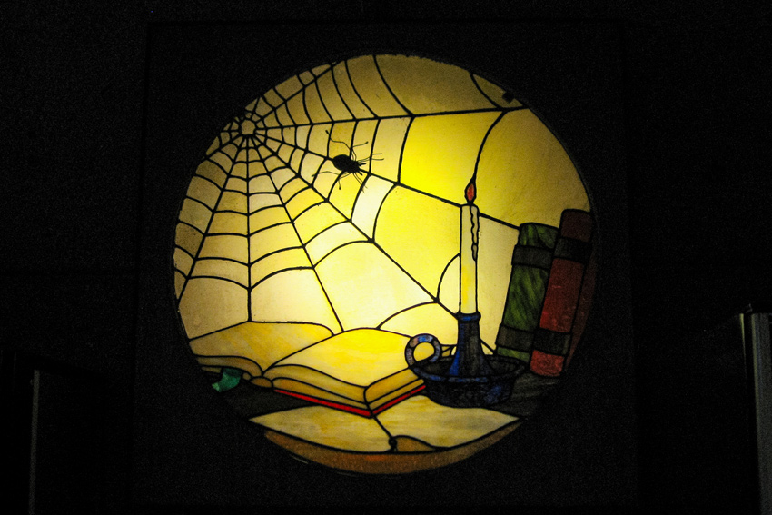 The stained glass window rescued from the Sutro Mansion library now hangs backlit in the Sutro Tower building