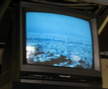 A monitor on the Sutro Tower building ground floor shows the view from a camera mounted above